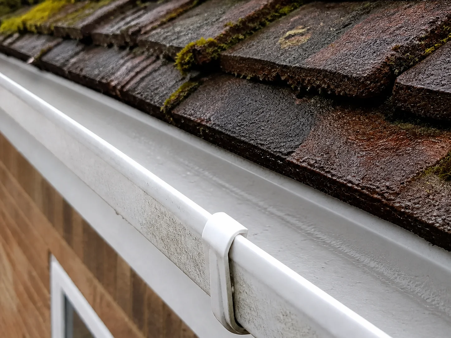 The same gutter after leaves and moss have been cleared